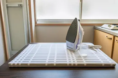 a computer monitor sitting on top of a bed at Sumida Skytree hostel in Tokyo