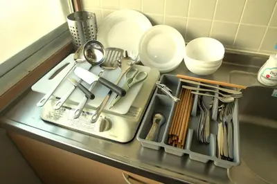 a kitchen counter with a tray of utensils at Sumida Skytree hostel in Tokyo
