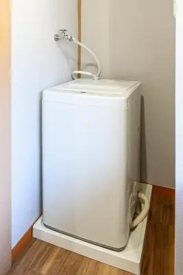 a white refrigerator in a corner of a room at Sumida Skytree hostel in Tokyo