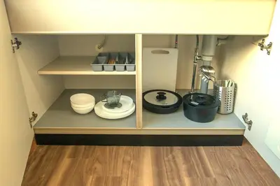 a cupboard with plates and other kitchen items in it at Sumida Skytree hostel in Tokyo