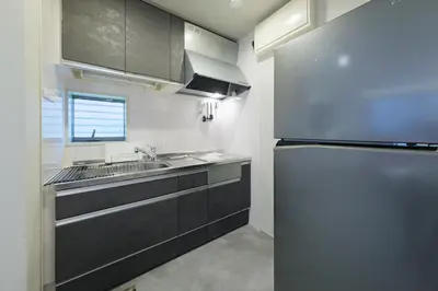 a kitchen with a refrigerator and a sink at Make Your Hotel\u5e61\u30f6\u8c37 in Tokyo
