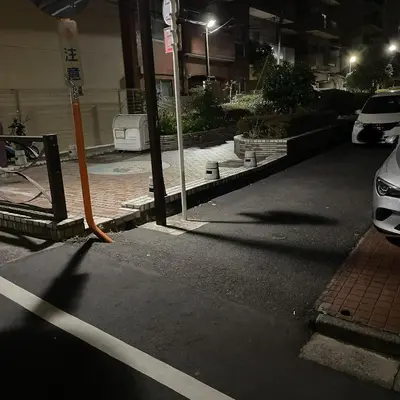 a street at night with a car parked in a parking lot at Ikebukuro Urban Retreat in Tokyo