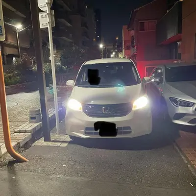 a white car parked at a gas station at night at Ikebukuro Urban Retreat in Tokyo
