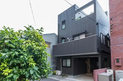 a house with a black facade at Ikebukuro Urban Retreat in Tokyo