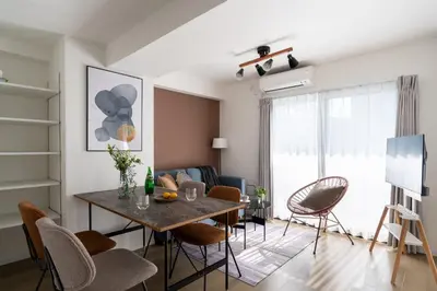 a living room with a dining room table and chairs at Teto\u65e9\u7a32\u7530 in Tokyo