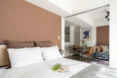 a bedroom with a bed with a book on it at Teto\u65e9\u7a32\u7530 in Tokyo