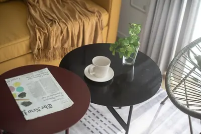 a black table with a cup of coffee and a newspaper at Teto\u65e9\u7a32\u7530 in Tokyo