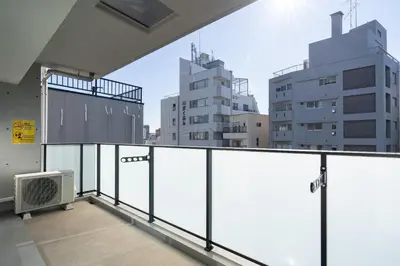 an empty balcony with a view of some buildings at Teto\u65e9\u7a32\u7530 in Tokyo