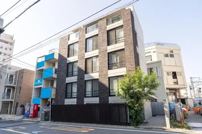 a building on a street with a tree in front of it at Exam\u9ad8\u7530\u99ac\u5834 in Tokyo