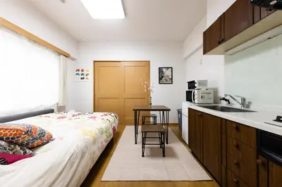 a kitchen with a bed and a sink in a room at SHIBUYA Bright Modern 40sqm Apartment FAMILY FRIENDLY!! in Tokyo