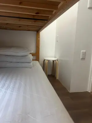 a bedroom with a white bed and a table at \u677f\u6a4b - \u4e09\u56fd\u5c45Guest House in Tokyo