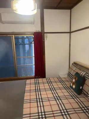 a bedroom with a bed and a window at \u677f\u6a4b - \u4e09\u56fd\u5c45Guest House in Tokyo