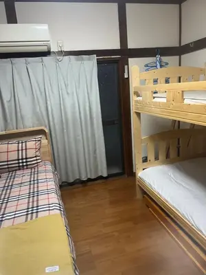 a room with two bunk beds and a window at \u677f\u6a4b - \u4e09\u56fd\u5c45Guest House in Tokyo