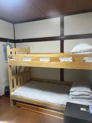 two bunk beds are in a room with at \u677f\u6a4b - \u4e09\u56fd\u5c45Guest House in Tokyo