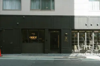 a black building with a sign that reads odyssey at Hotel Vintage Tokyo Meguro Fudomae in Tokyo