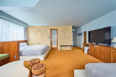 a hotel room with two beds and a flat screen tv at Hotel Vintage Tokyo Meguro Fudomae in Tokyo