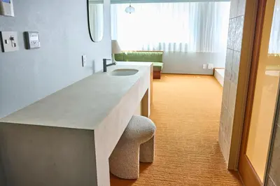 a bathroom with a counter with a sink and a stool at Hotel Vintage Tokyo Meguro Fudomae in Tokyo
