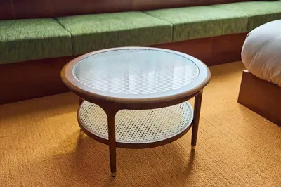 a wooden stool with a glass table in front of a couch at Hotel Vintage Tokyo Meguro Fudomae in Tokyo