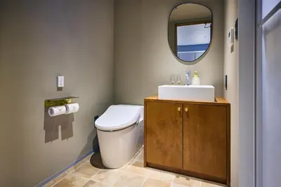 a bathroom with a toilet and a sink and a mirror at Hotel Vintage Tokyo Meguro Fudomae in Tokyo
