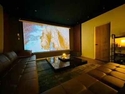 a large screen in a living room with a couch at The Hills Suite Daikanyama & Omotesando-Shibuya-Harajuku-Meiji Shrine & 10-minute walk from Daikanyama in Tokyo