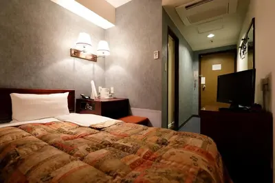 a bedroom with a large bed and a television at Tokyo Inn - Vacation STAY 26513v in Tokyo