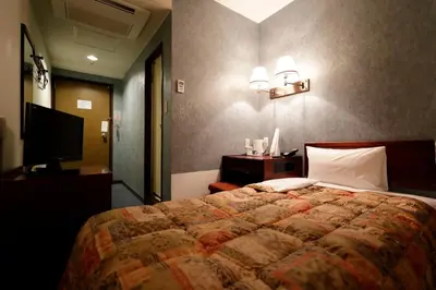 a bedroom with a large bed and a television at Tokyo Inn - Vacation STAY 26513v in Tokyo