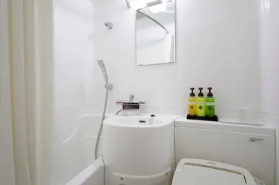 a white bathroom with a toilet and a sink at Tokyo Inn - Vacation STAY 26513v in Tokyo