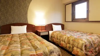 a hotel room with two beds and a window at Tokyo Inn - Vacation STAY 26584v in Tokyo