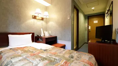 a bedroom with a bed and a flat screen tv at Tokyo Inn - Vacation STAY 26668v in Tokyo