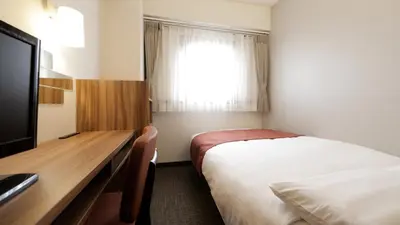 a hotel room with a bed and a desk and a window at Tokyo Inn - Vacation STAY 26555v in Tokyo