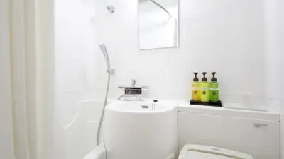 a white bathroom with a toilet and a sink at Tokyo Inn - Vacation STAY 26569v in Tokyo