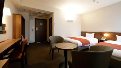 a hotel room with two beds and a table and chairs at Tokyo Inn - Vacation STAY 26708v in Tokyo