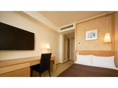 a hotel room with a bed and a desk and a television at The OneFive Tokyo Kameido - Vacation STAY 64573v in Tokyo
