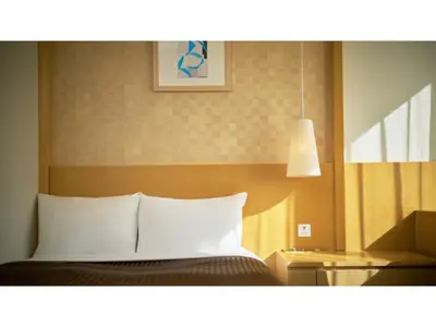 a bedroom with a bed with a white pillow at The OneFive Tokyo Kameido - Vacation STAY 64595v in Tokyo