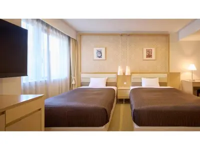 a hotel room with two beds and a flat screen tv at The OneFive Tokyo Kameido - Vacation STAY 64628v in Tokyo