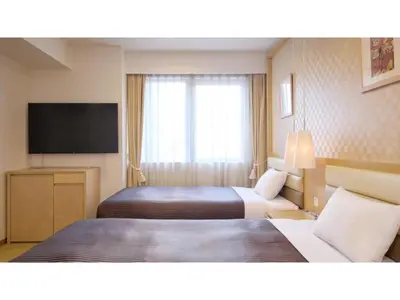 a hotel room with two beds and a flat screen tv at The OneFive Tokyo Kameido - Vacation STAY 64628v in Tokyo
