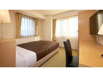 a bedroom with a bed and a desk and a television at The OneFive Tokyo Kameido - Vacation STAY 64608v in Tokyo