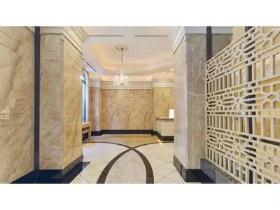 a hallway with marble walls and a chandelier at The OneFive Tokyo Kameido - Vacation STAY 64559v in Tokyo