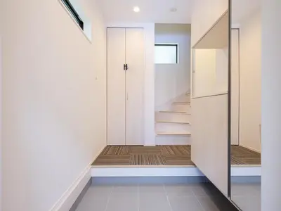 a hallway with a door and stairs in a house at Four Seasons Yado1 in Tokyo