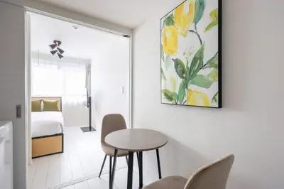 a room with a table and chairs and a bedroom at Brio\u9ad8\u4e95\u6238 in Tokyo