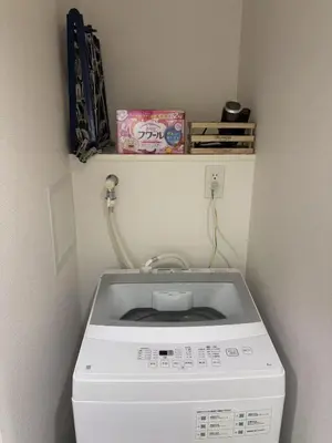 a washer and dryer in a corner of a room at SHIBUYA Room in Tokyo
