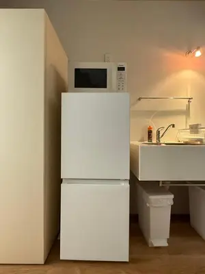 a white refrigerator in a kitchen with a microwave at Lumiere Minami-Shinagawa B in Tokyo