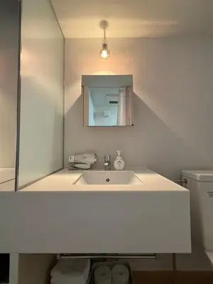 a white bathroom with a sink and a mirror at Lumiere Minami-Shinagawa B in Tokyo