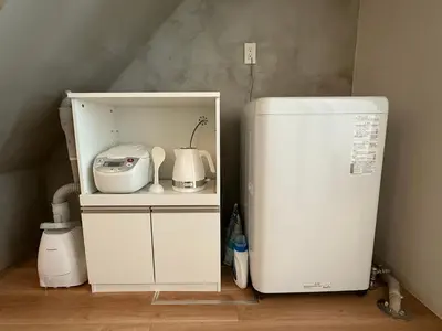 a small kitchen with a white refrigerator in a room at Lumiere Minami-Shinagawa B in Tokyo