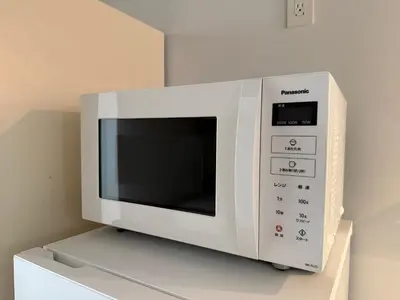 a microwave oven sitting on top of a refrigerator at Lumiere Minami-Shinagawa B in Tokyo
