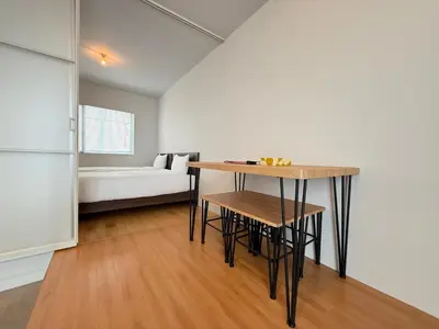 a kitchen with a table and a bed in a room at Lumiere Minami-Shinagawa B in Tokyo