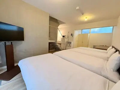 a hotel room with two beds and a flat screen tv at Lumiere Minami-Shinagawa B in Tokyo