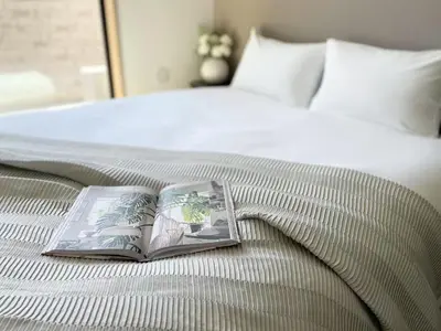a book sitting on top of a bed at Comma House Kitaikebukuro 301 in Tokyo