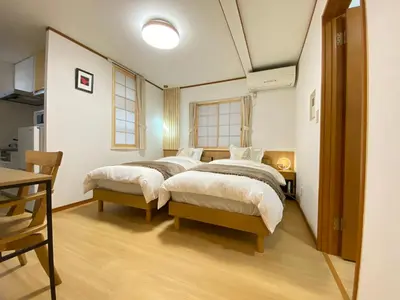 a bedroom with two beds and a table at N28-Tokyo Shinjuku Luxury Villa 110 SPM in Tokyo