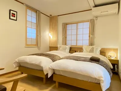 two beds in a room with two windows at N28-Tokyo Shinjuku Luxury Villa 110 SPM in Tokyo